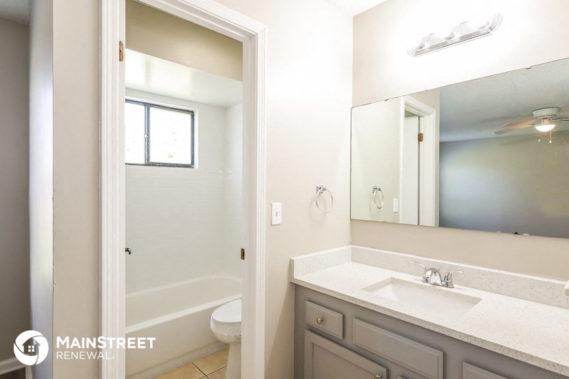 a bathroom with a sink and a mirror and a toilet