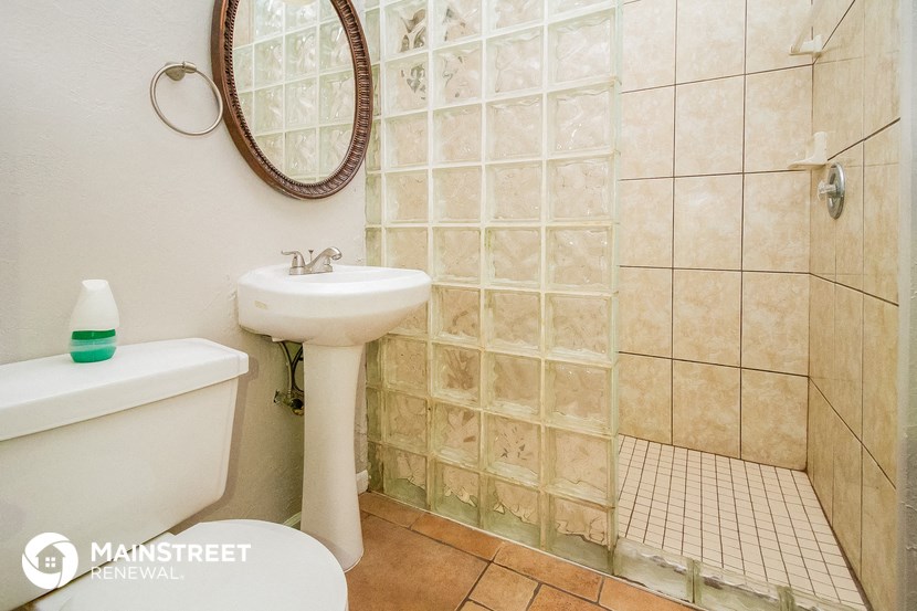 a white bathroom with a sink and a toilet