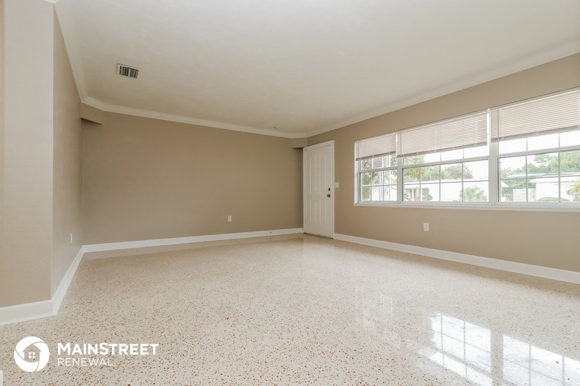 an empty living room with a large window