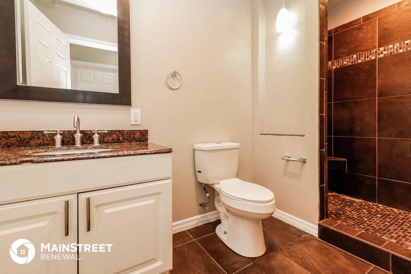 a bathroom with a toilet and a sink and a shower