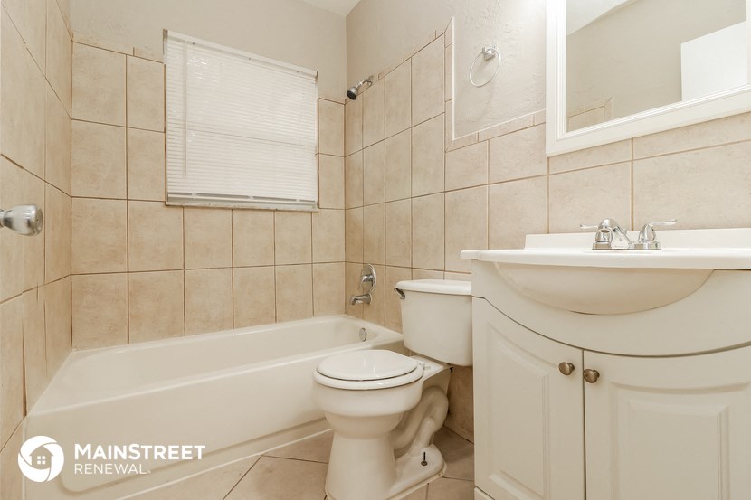a bathroom with a toilet and a sink and a bath tub