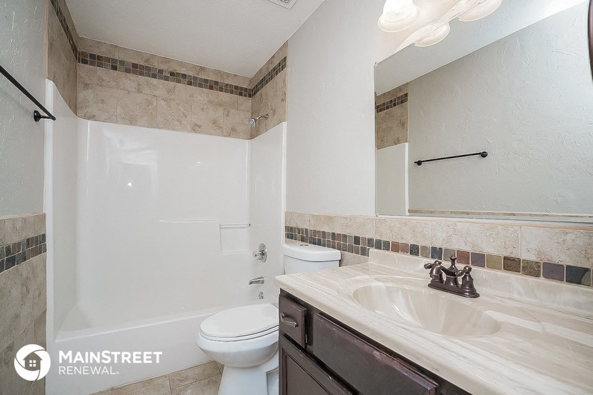 a bathroom with a sink and a toilet and a shower