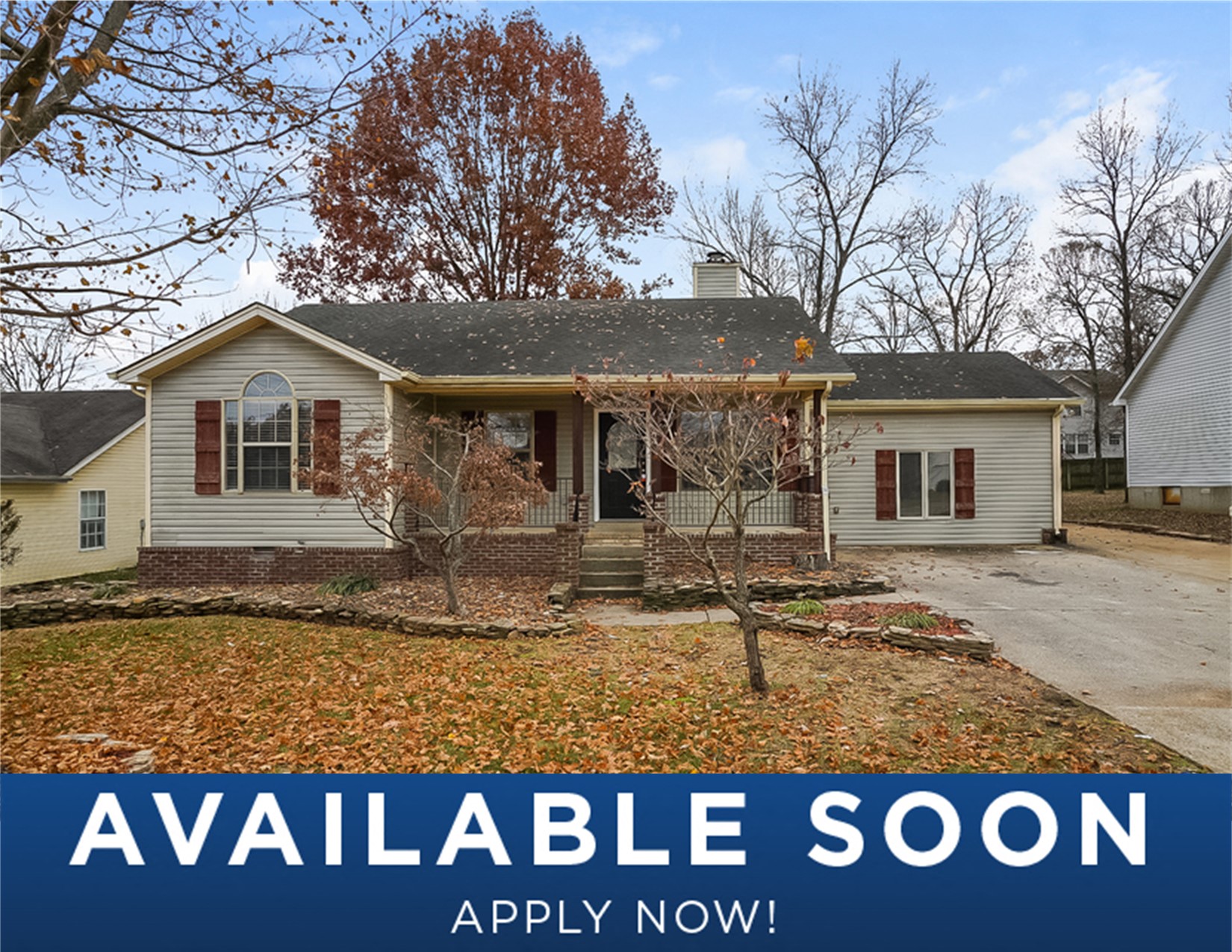 a white house with a yard and trees in front of it