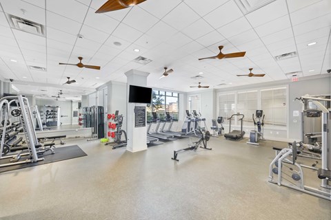 A spacious gym with a variety of equipment and a flat floor.