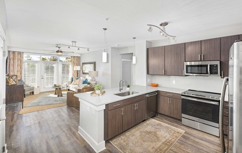 A kitchen with wooden cabinets and a white island.