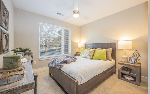 a bedroom with a large bed and a ceiling fan