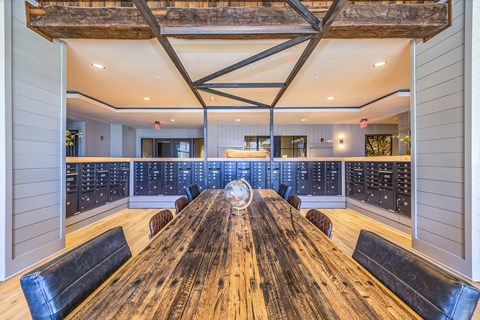 a tasting room with a wooden table and bottles of wine