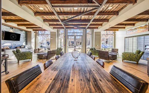 a large dining room with a large wooden table and chairs
