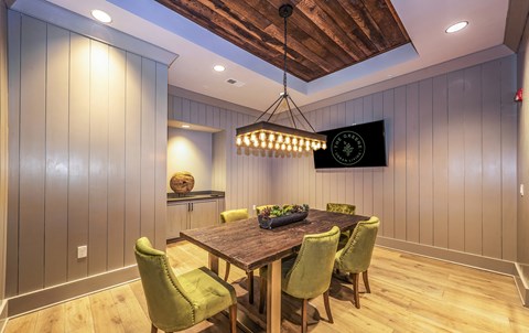 a dining room with a wooden table and green chairs