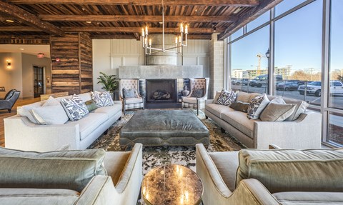 a living room with couches and a table and a fireplace