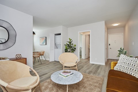 Living room seating area with view of in-unit washer and dryer