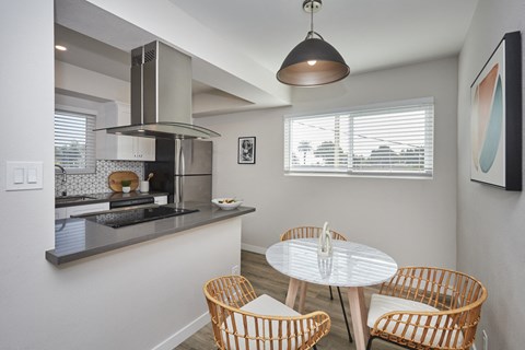 a kitchen and dining room with a table and chairs