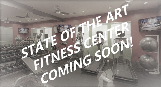 A gym with a sign that says "State of the art fitness center coming soon!".