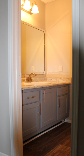 A bathroom with a sink and cabinets.