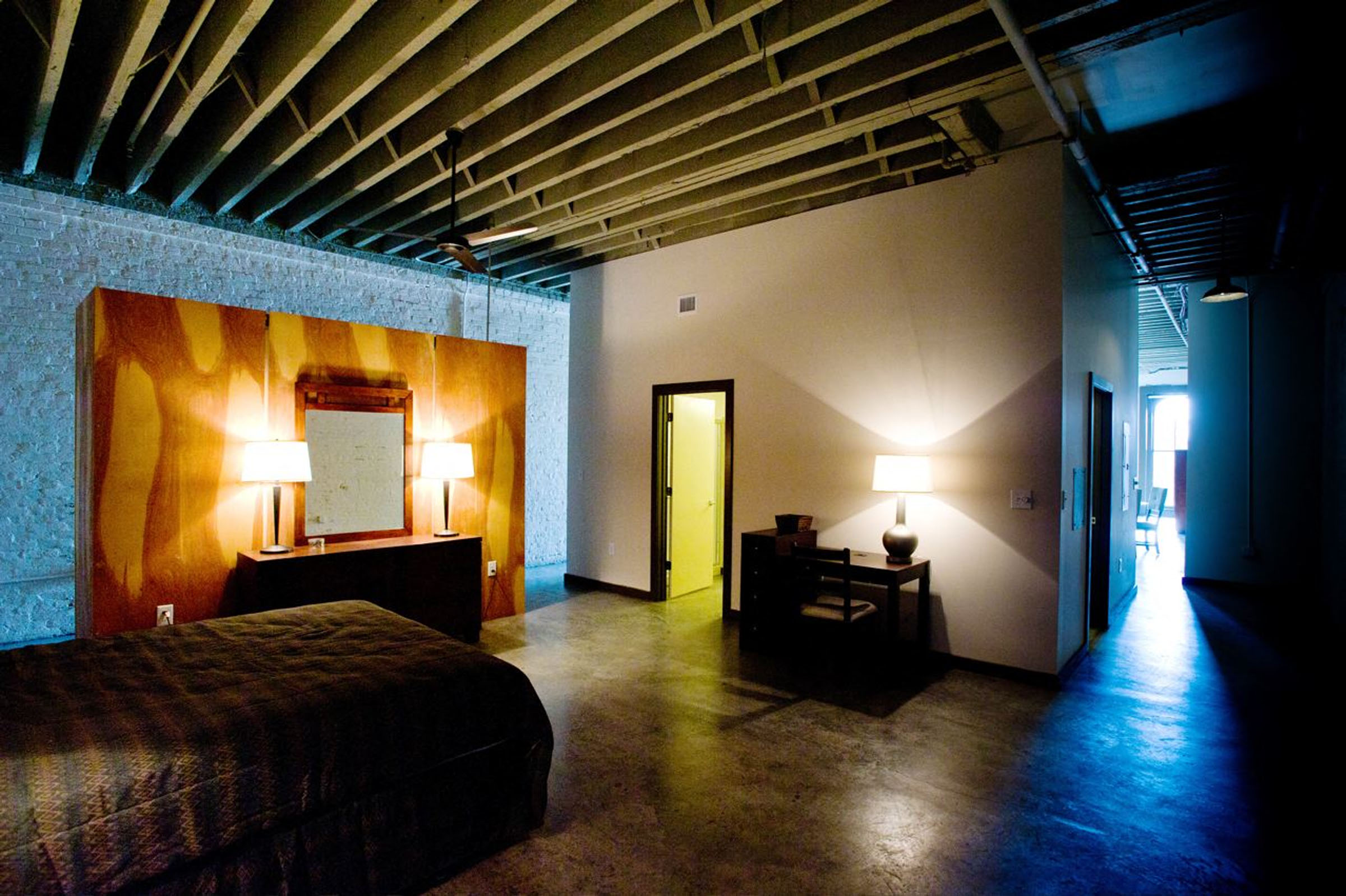 a hotel room with a bed and a desk in it