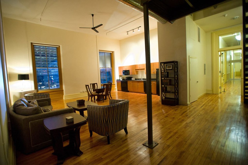 an empty living room with a dining room and a kitchen
