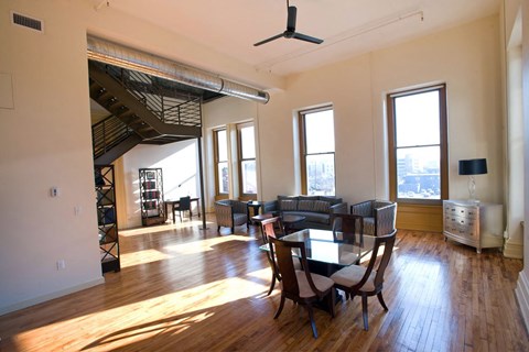 an empty living room with a dining room table and chairs