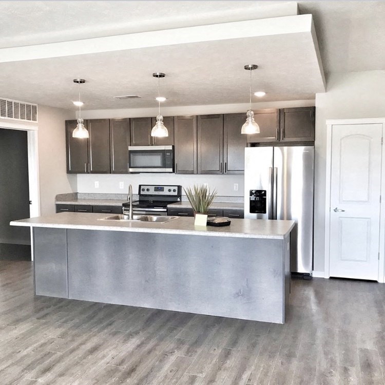 a kitchen with stainless steel appliances and a counter top