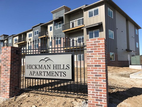 a sign apartments in front of an apartment building