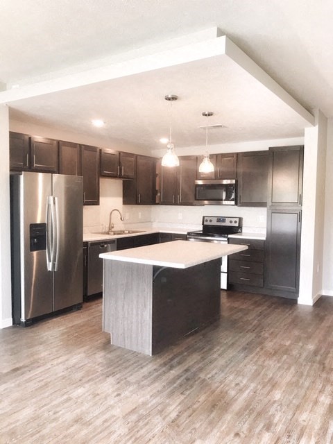 a kitchen with stainless steel appliances and a white counter top