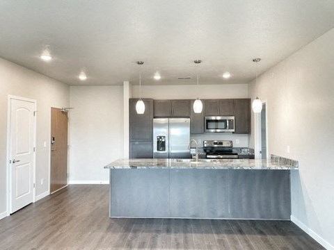 an empty kitchen with a counter top