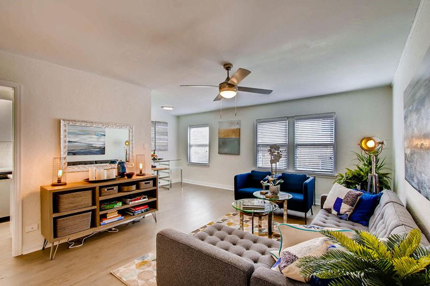 a living room with a couch and a ceiling fan