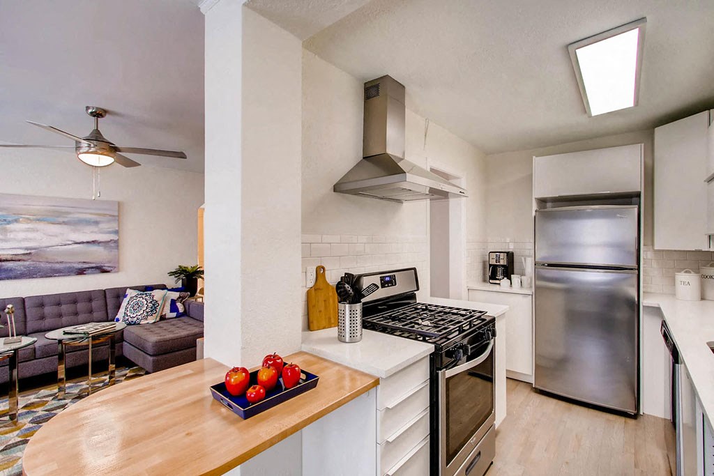 a kitchen with stainless steel appliances and a counter top