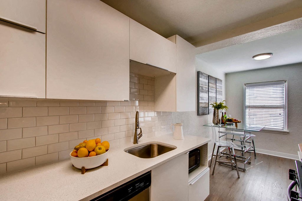 a kitchen with a bowl of fruit on the counter