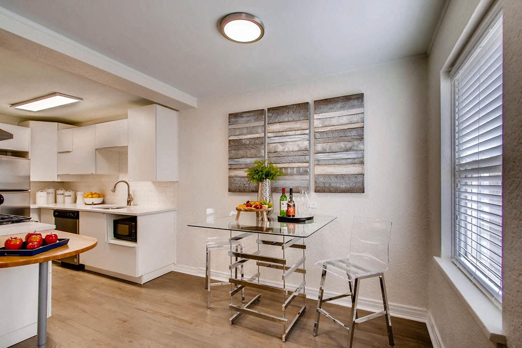 a kitchen and dining room with a table and chairs