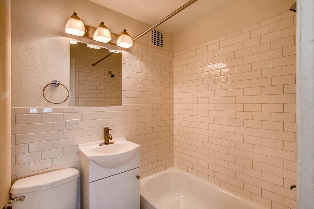 a bathroom with a sink toilet and a mirror