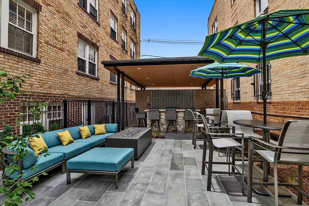 a patio with tables and chairs and umbrellas