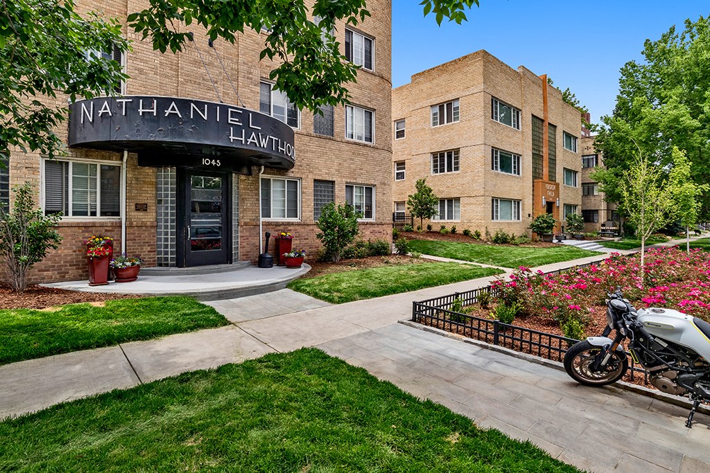 a motorcycle parked outside of a building at nathaniel hall apartments