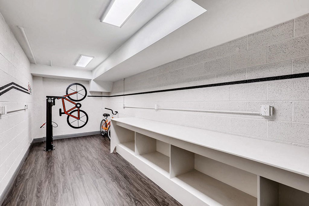 a storage room with white shelves and a bike on the wall