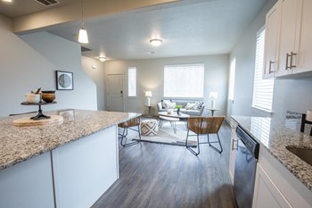 Model apartment home kitchen, dining and living room from a different angle