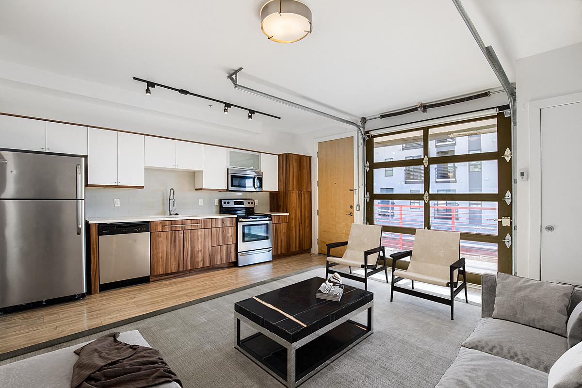 a living room with a kitchen and a couch