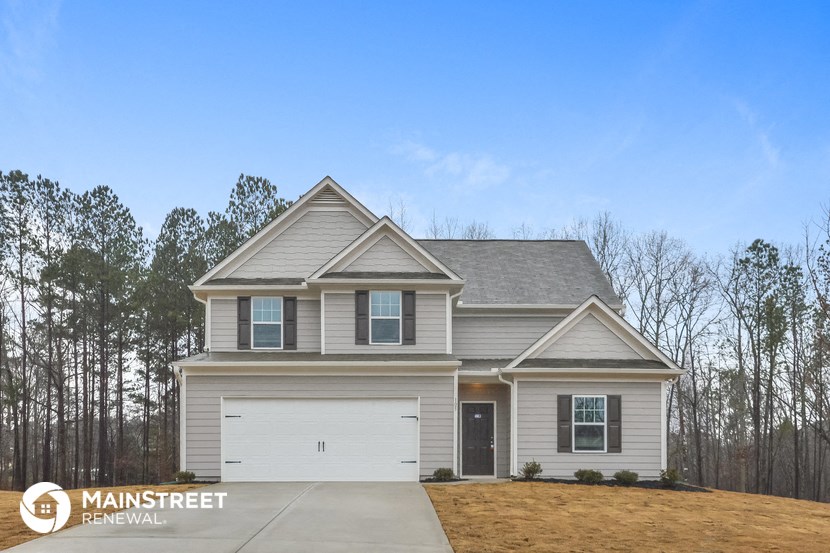 a home with a white garage door and a gray house