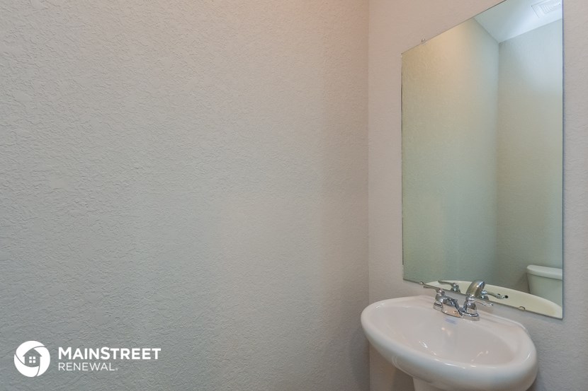 a small bathroom with a sink and a mirror