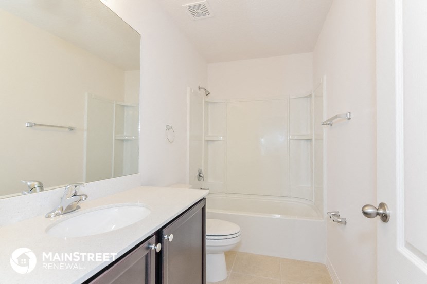 a white bathroom with a sink toilet and shower