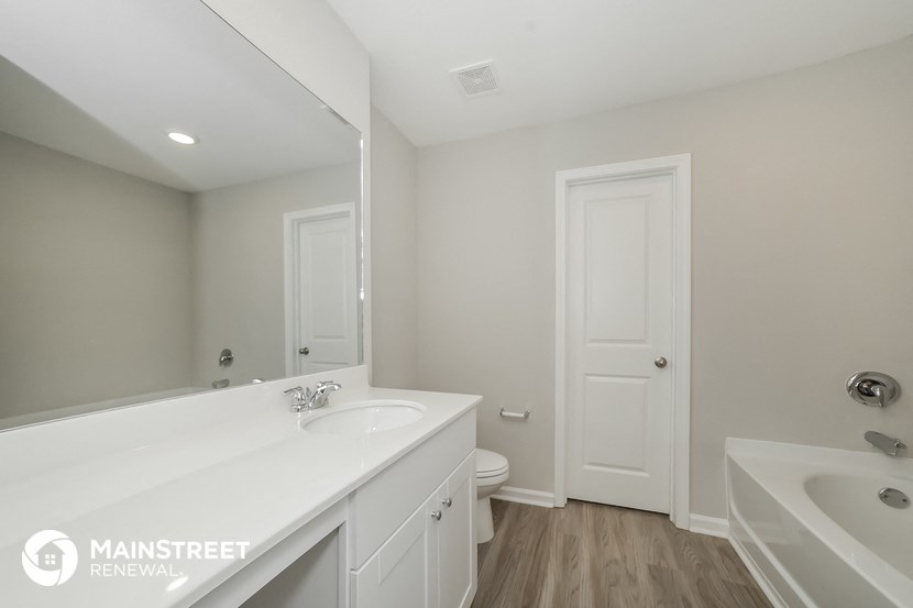 a bathroom with a sink and a toilet and a mirror