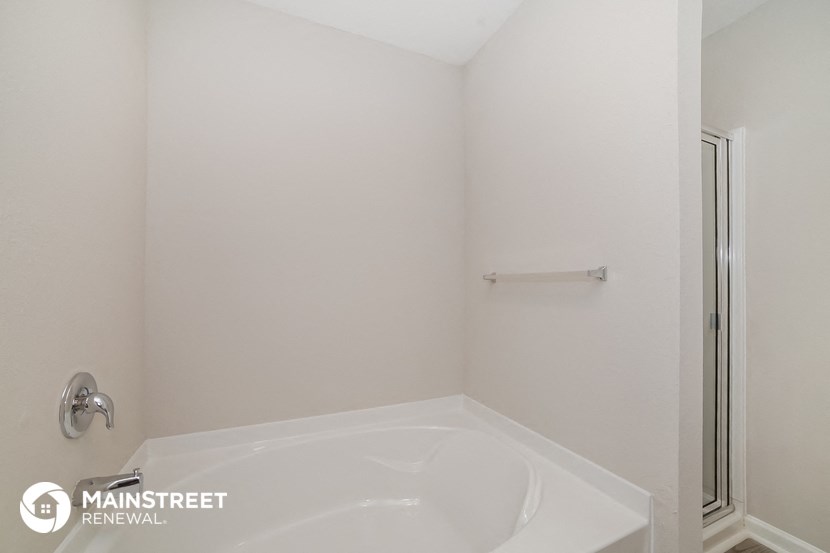 a small bathroom with a tub and a shower