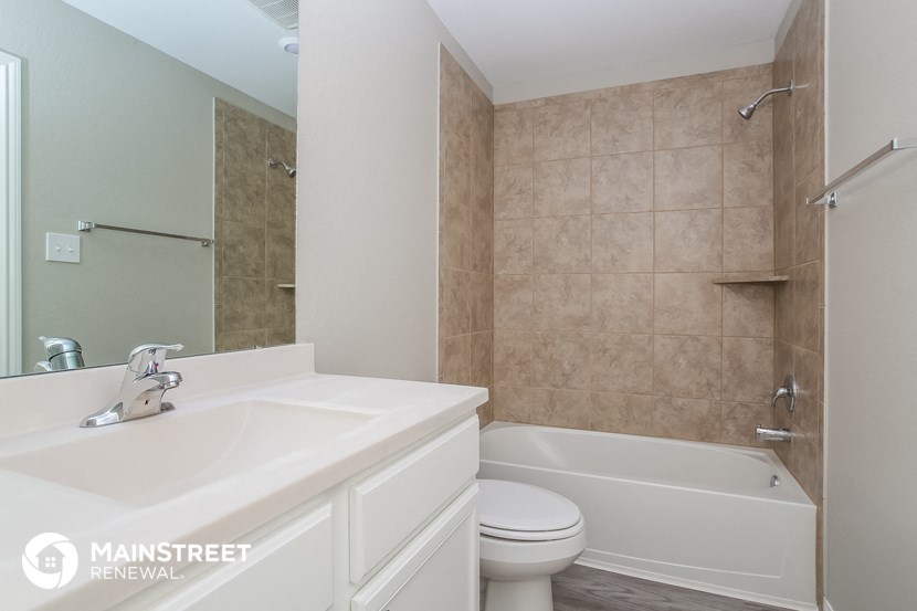 a bathroom with a sink and a toilet and a bath tub
