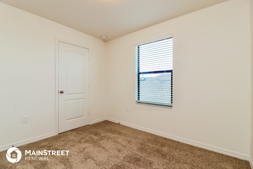 the master bedroom has carpeted floors and a door to the balcony