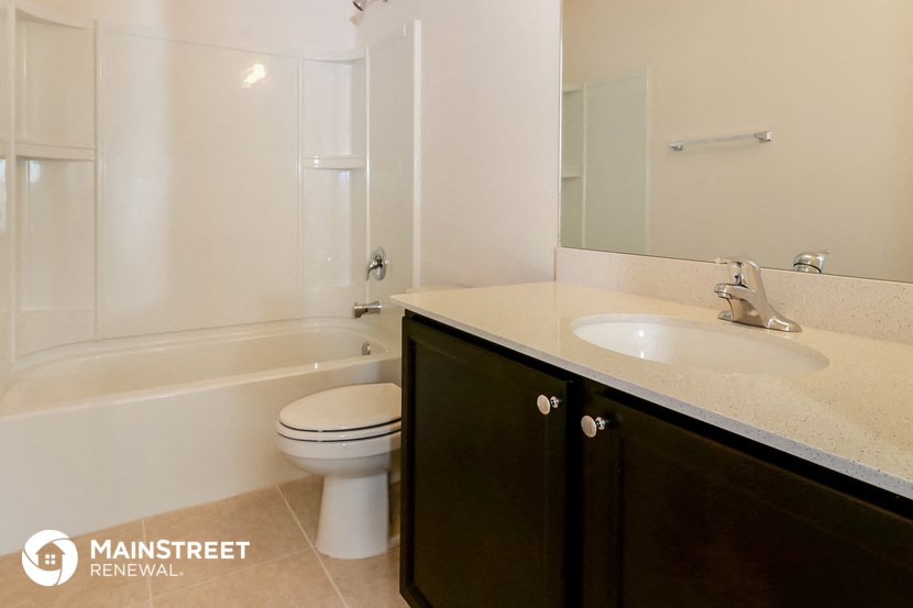 a bathroom with a sink and a toilet and a bath tub