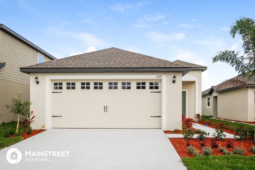 a white garage door in front of a house