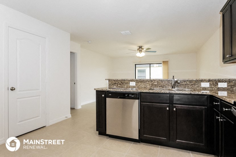 a kitchen with black cabinets and a granite counter top