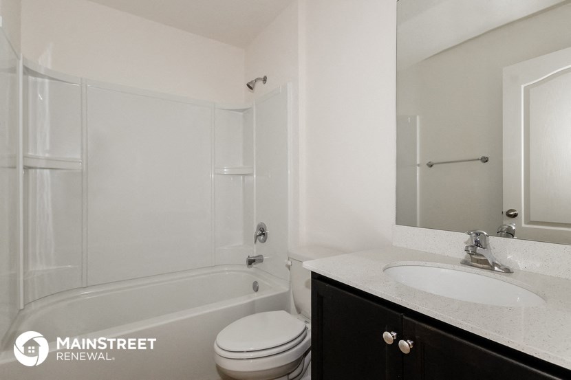 a white bathroom with a sink toilet and shower