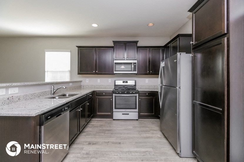 a kitchen with stainless steel appliances and granite counter tops