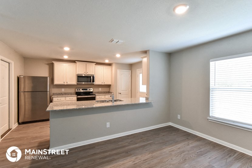 the kitchen is open to the living room and dining room