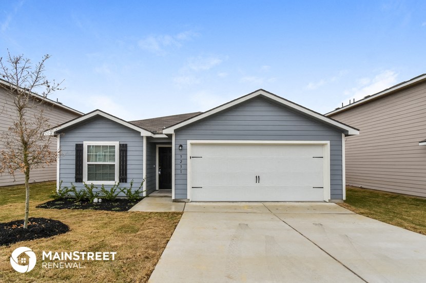 a blue house with a white garage door