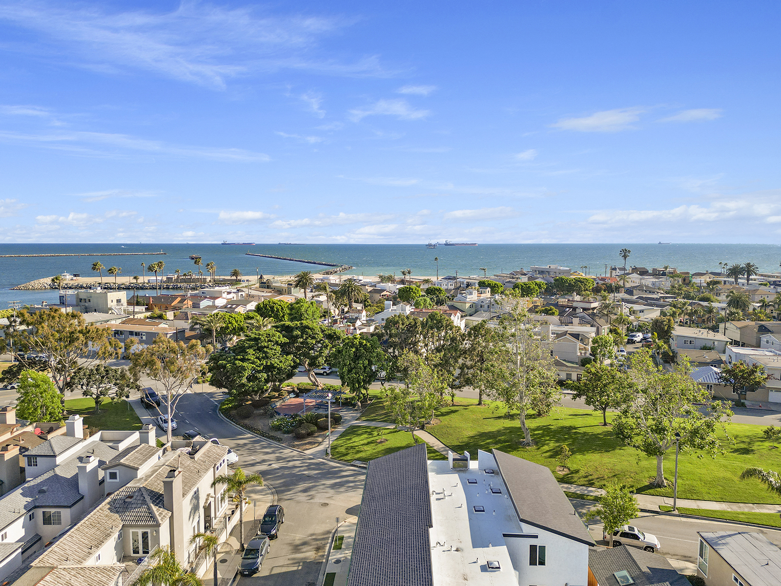 a view of the city and the ocean from the roof of a house